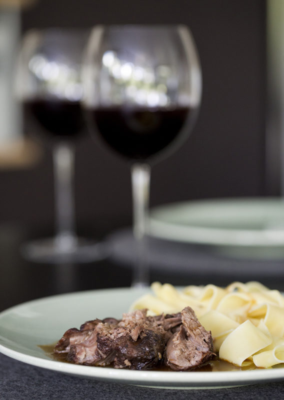 Slow-cooked braised beef on a layer of vegetables